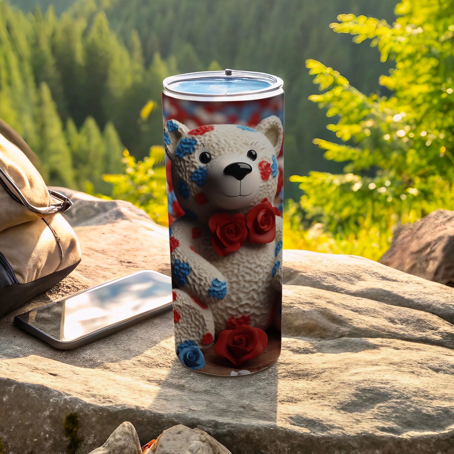White teddy bear tumbler with red and blue floral pattern and red bow tie.