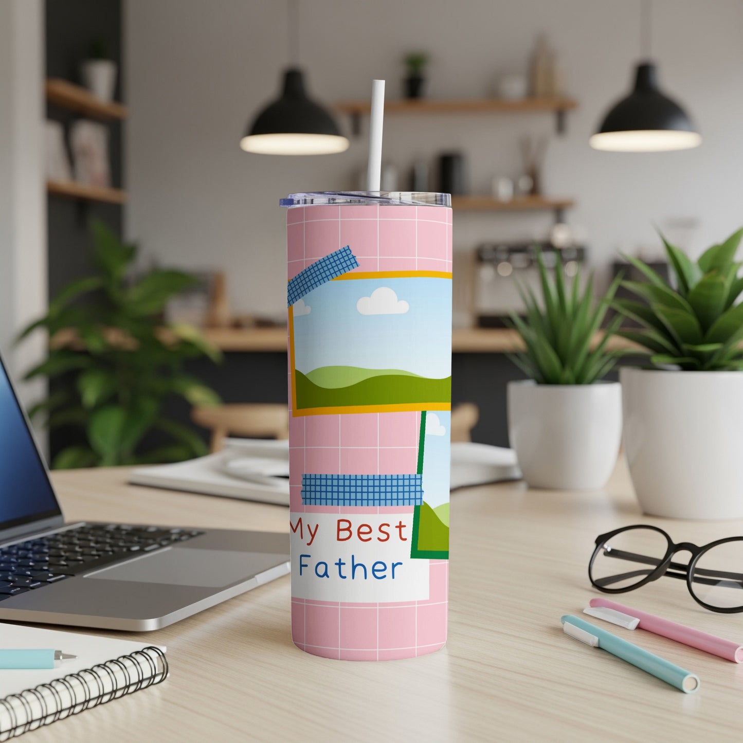 Pink tumbler with "My Best Father" text and faux photo frames, on a desk.