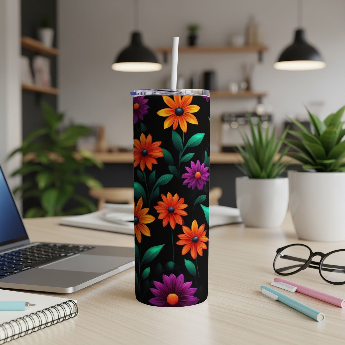 Black tumbler with colorful floral pattern, lid, and straw.