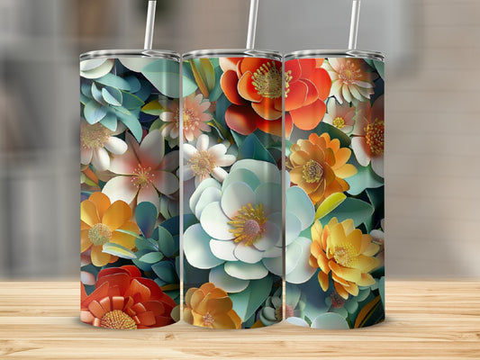 Three floral print tumblers with straw on a wooden surface.