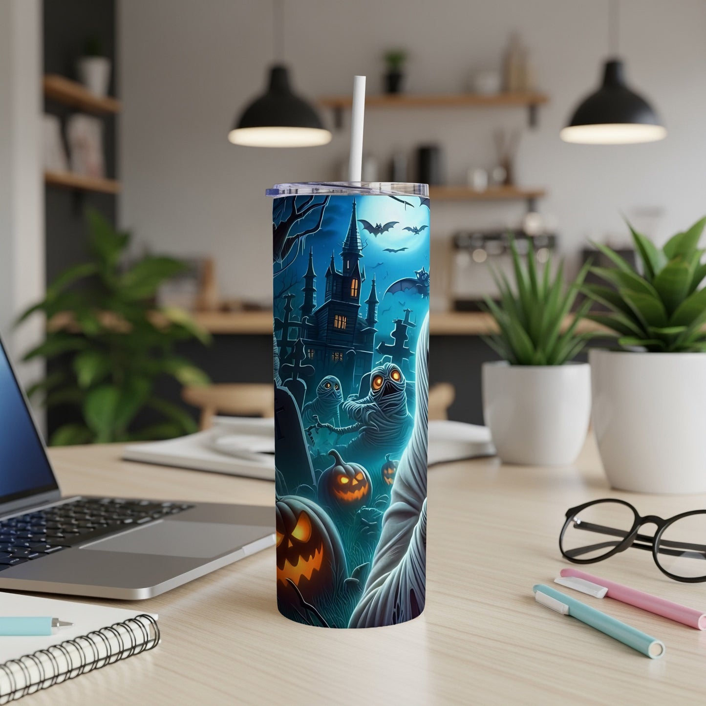 Tumbler with Halloween-themed art featuring mummies, pumpkins, and a haunted castle.