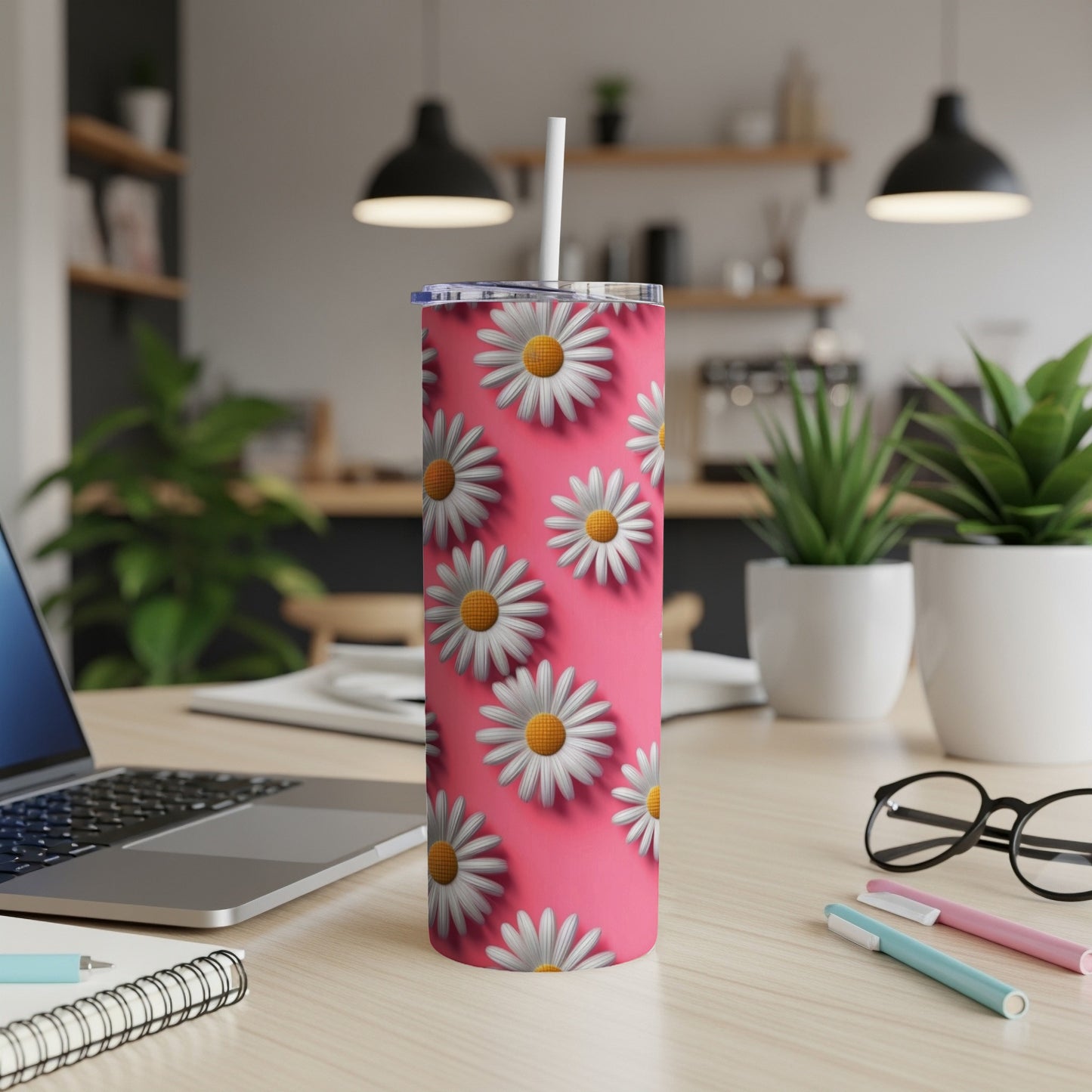 Pink tumbler with white daisy pattern and white straw.