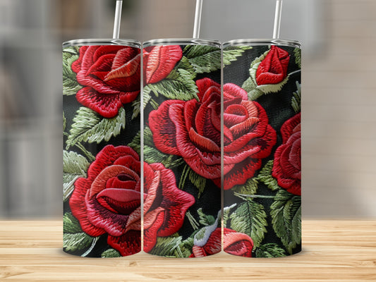 Three tumblers with embroidered red roses and green leaves on a black background.