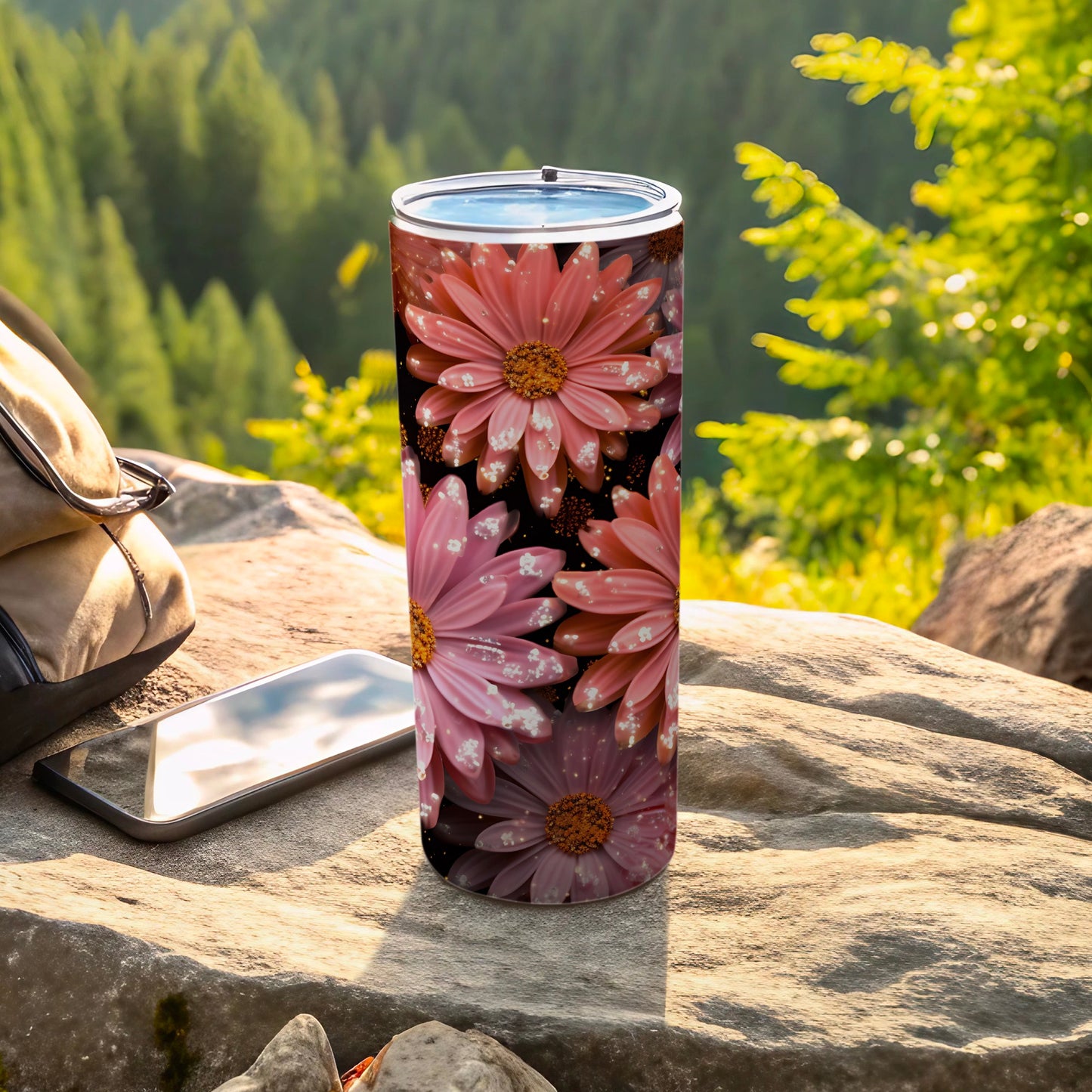 Pink daisy tumbler with sparkling accents on a rocky outcrop.