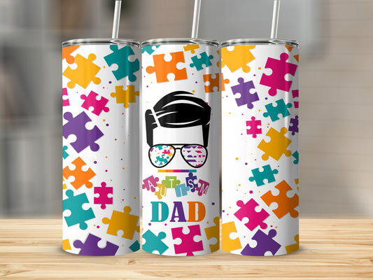 Dad tumbler with autism puzzle piece design and colorful background.