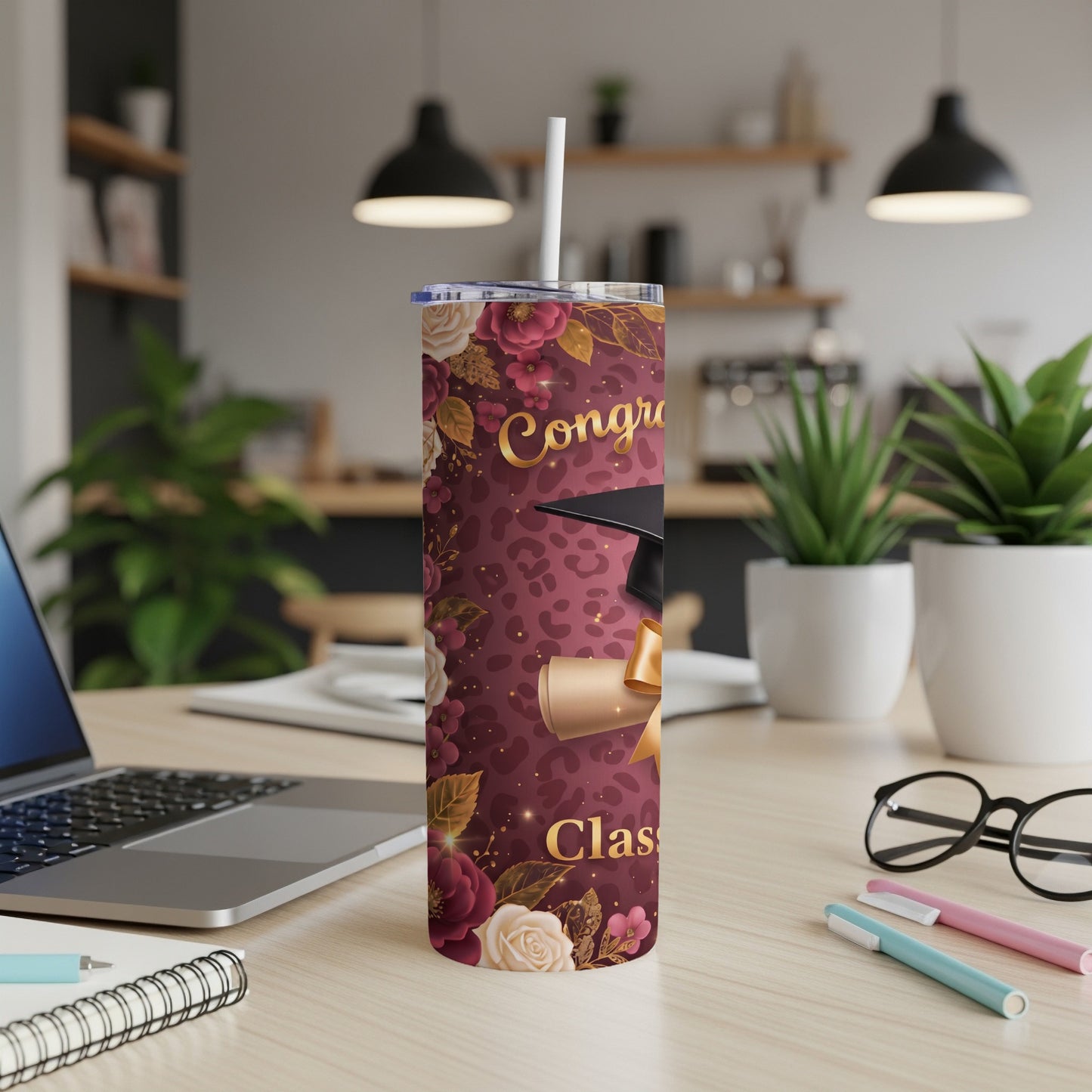 Maroon tumbler with graduation cap, diploma, and floral leopard print.