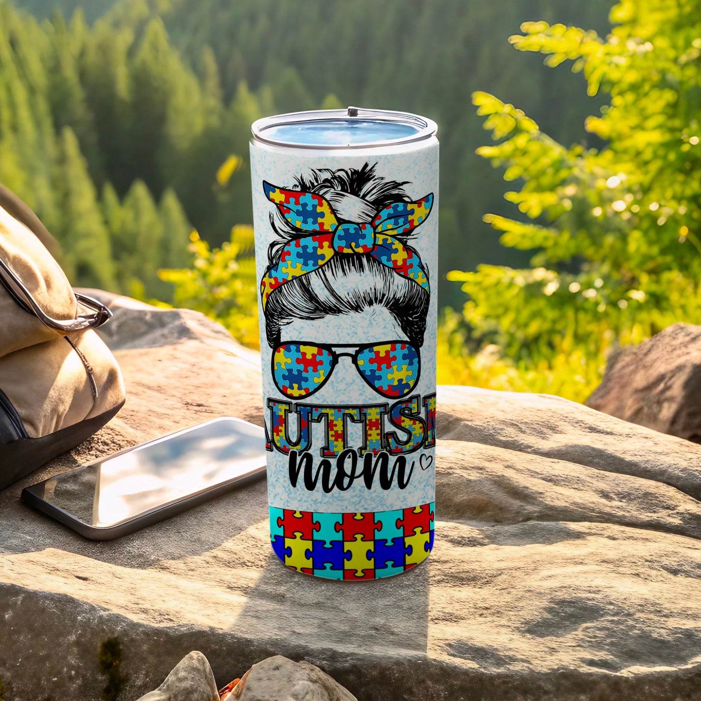 Autism mom tumbler with puzzle piece bandana and sunglasses.