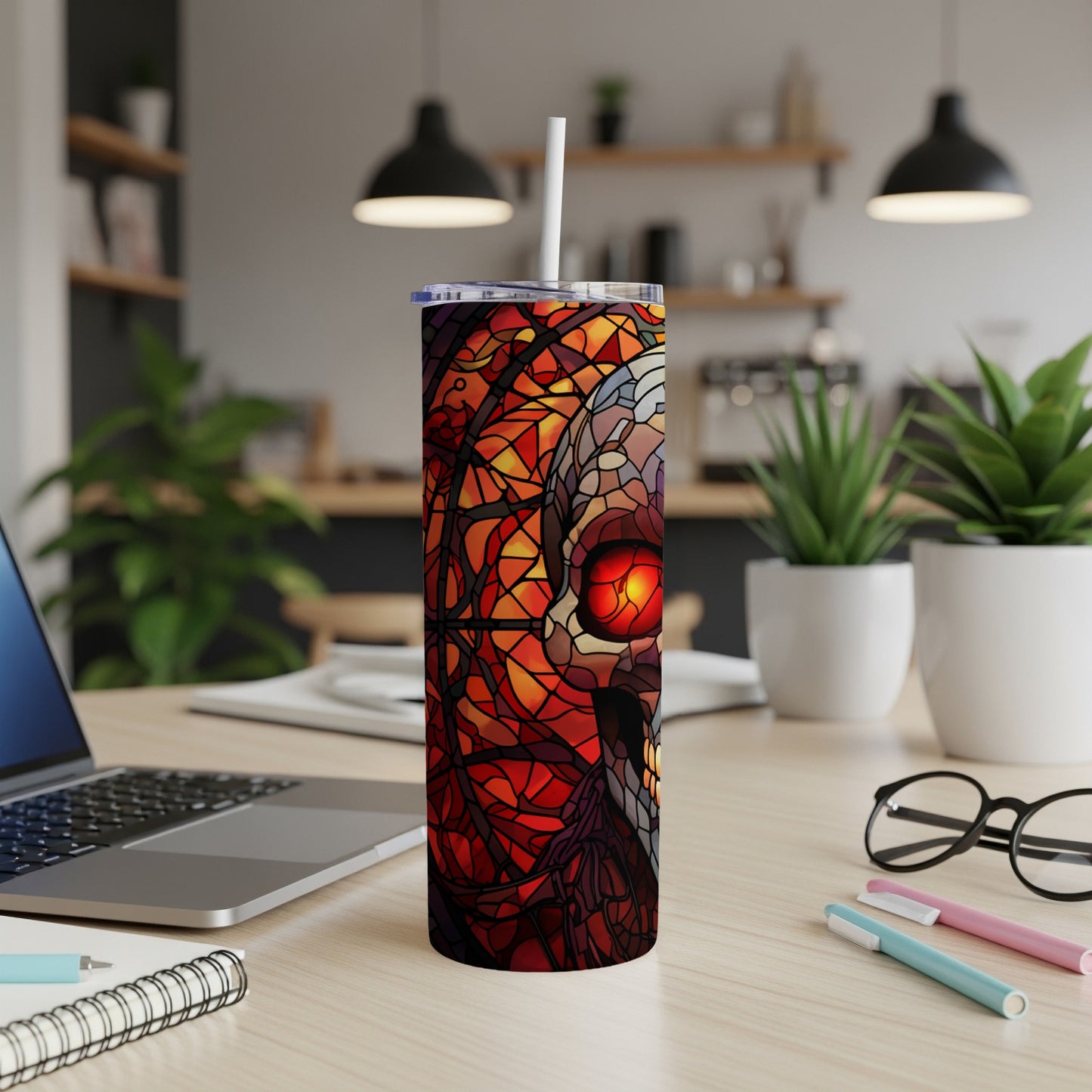 Stained glass skull design on a white tumbler with a straw.