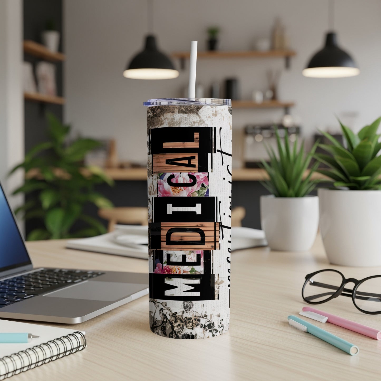"Medical" text on a rustic-patterned tumbler with a straw, on a desk.