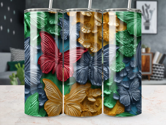Three tumblers with embossed butterflies and floral designs in red, grey, and gold.