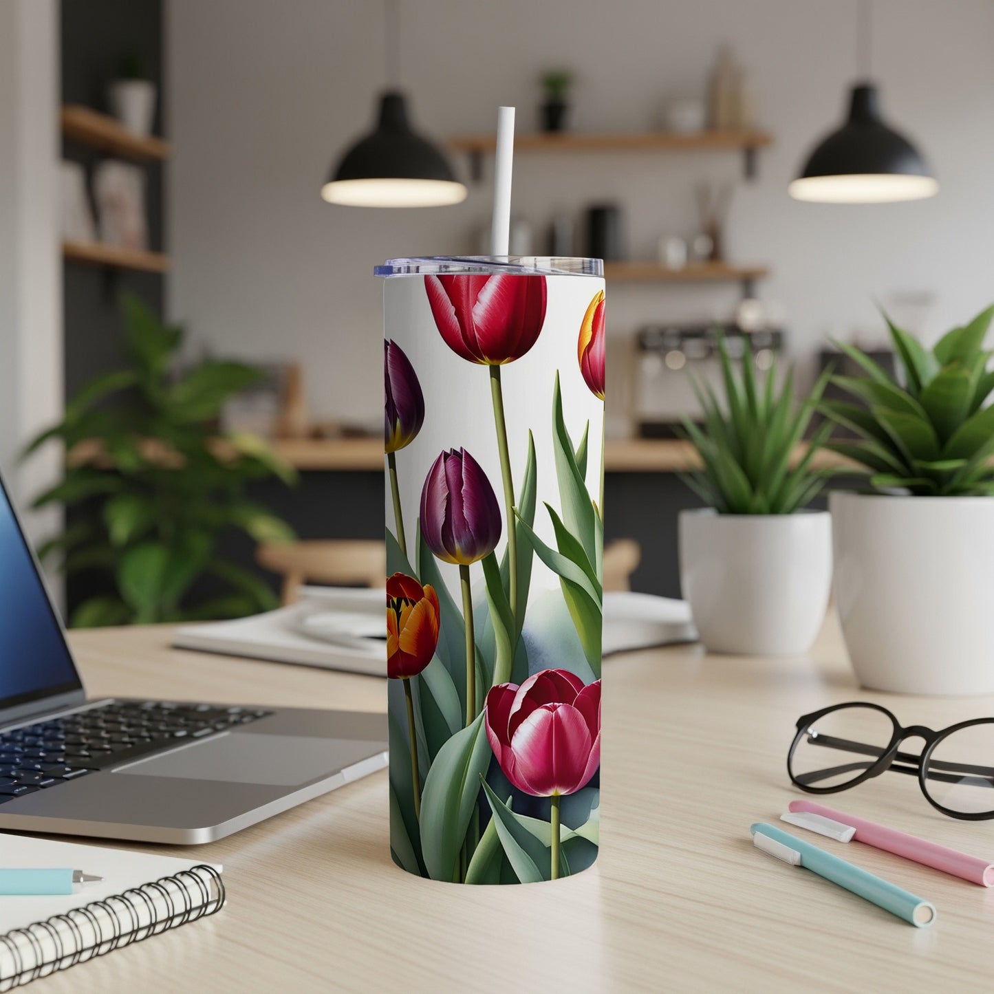 White tumbler with a repeating pattern of red and purple tulips and green leaves.
