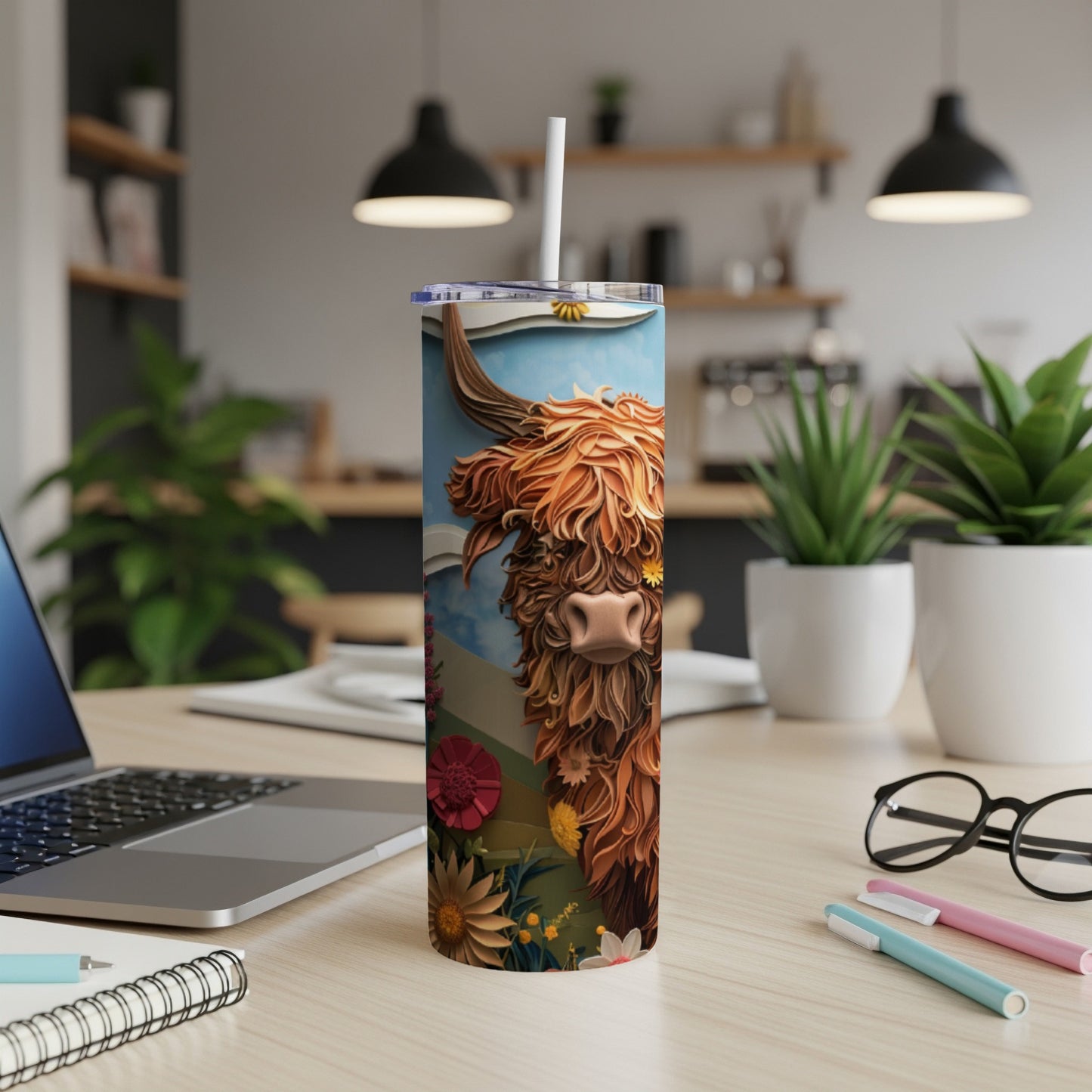 Highland cow illustration on a stainless steel tumbler with a straw.