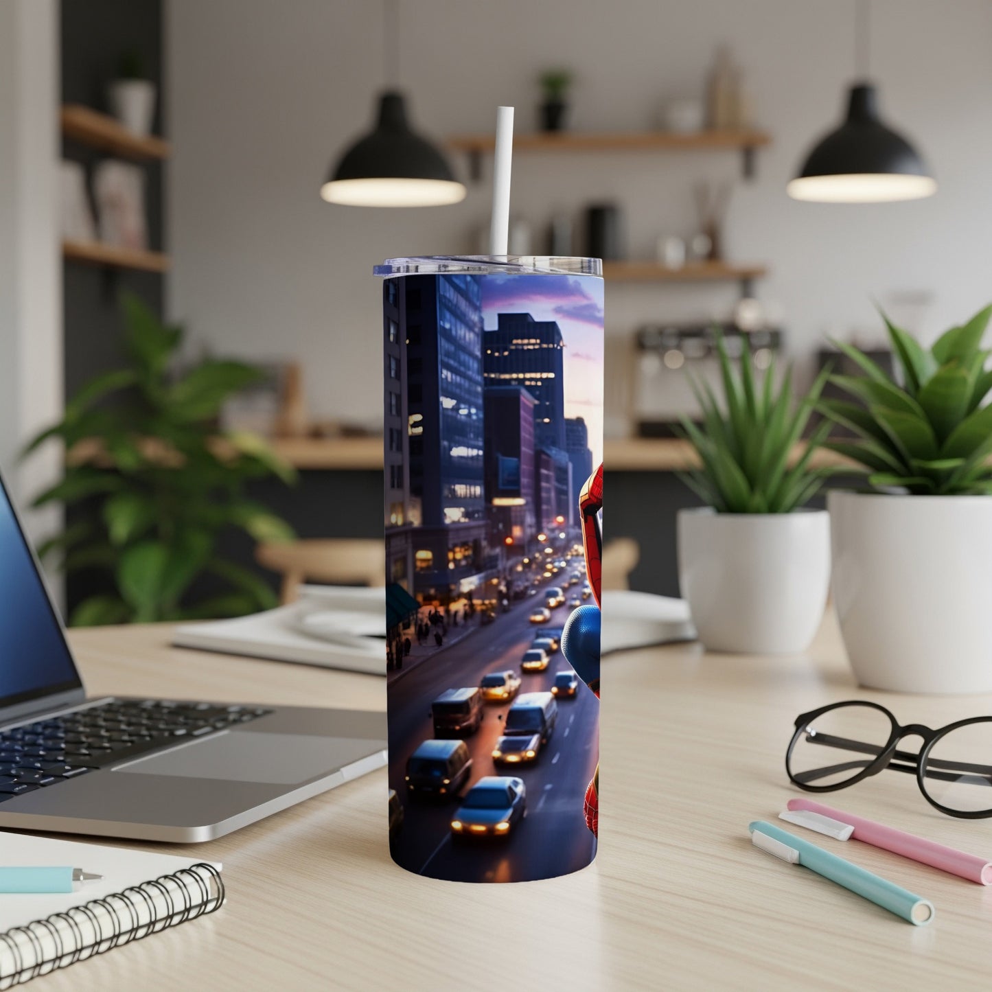 Spiderman character on a city street scene tumbler with straw on a desk.