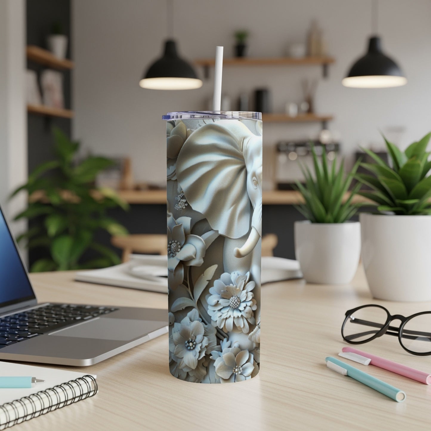 Tall tumbler with detailed elephant and floral relief pattern.