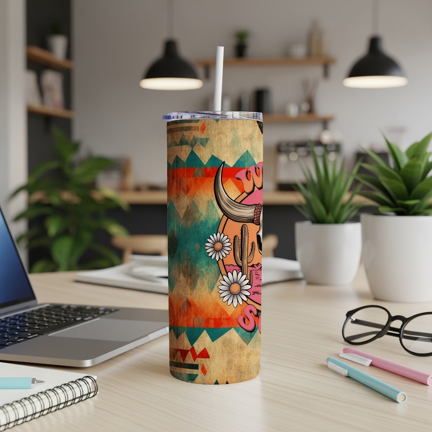 Cow skull with flowers and geometric pattern on a tumbler with straw.