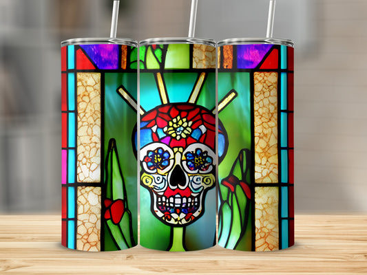 Three tumblers with colorful stained-glass skull designs on a wooden surface.