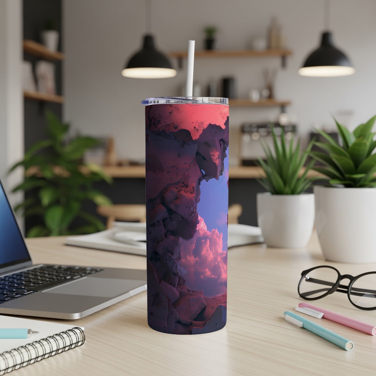 Tumbler with abstract rocky landscape and cloudy sky design.