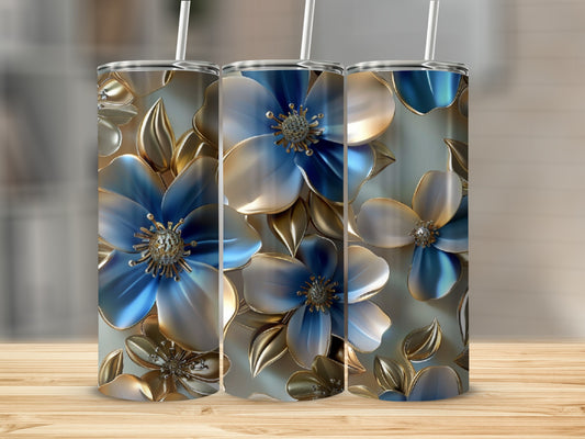 Three tumblers with blue and gold floral design and white straws.