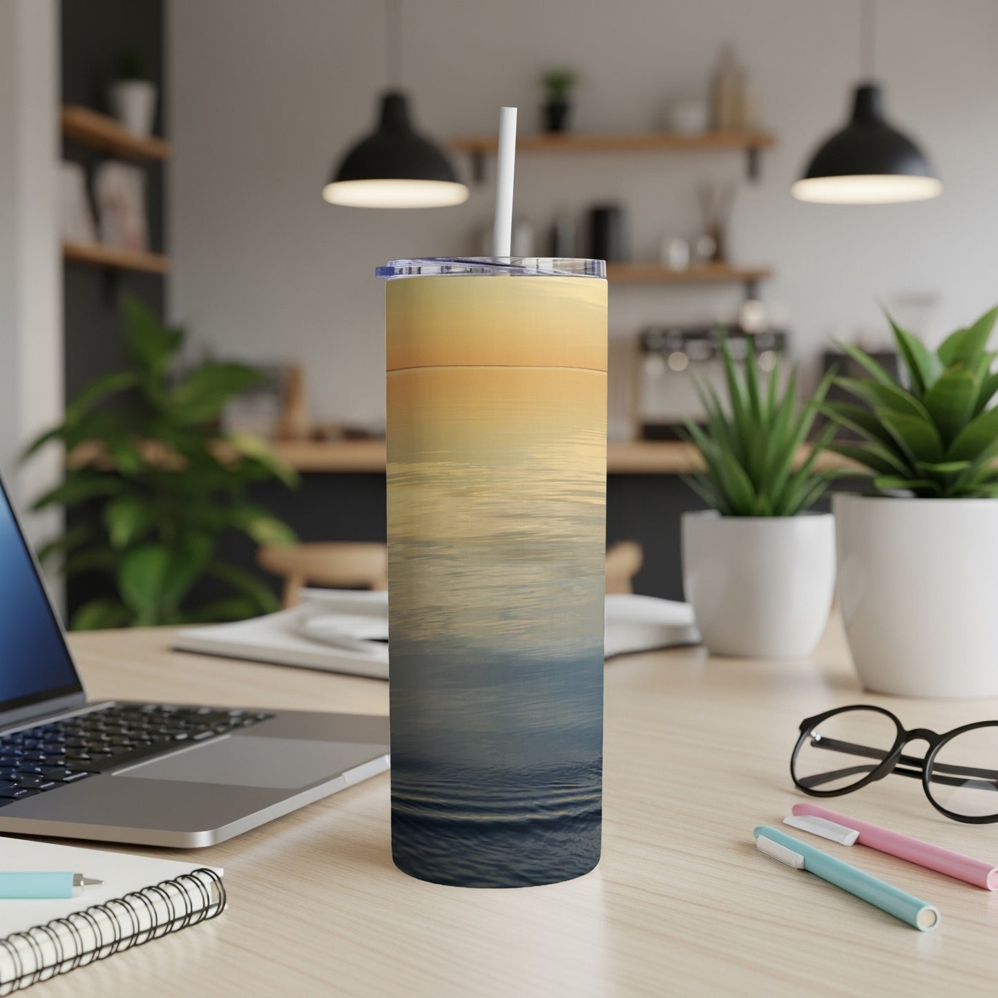 Ocean sunset waves design on a white tumbler with a straw.