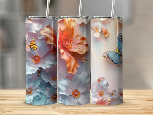 Three tumblers with floral and butterfly designs on a wooden surface.