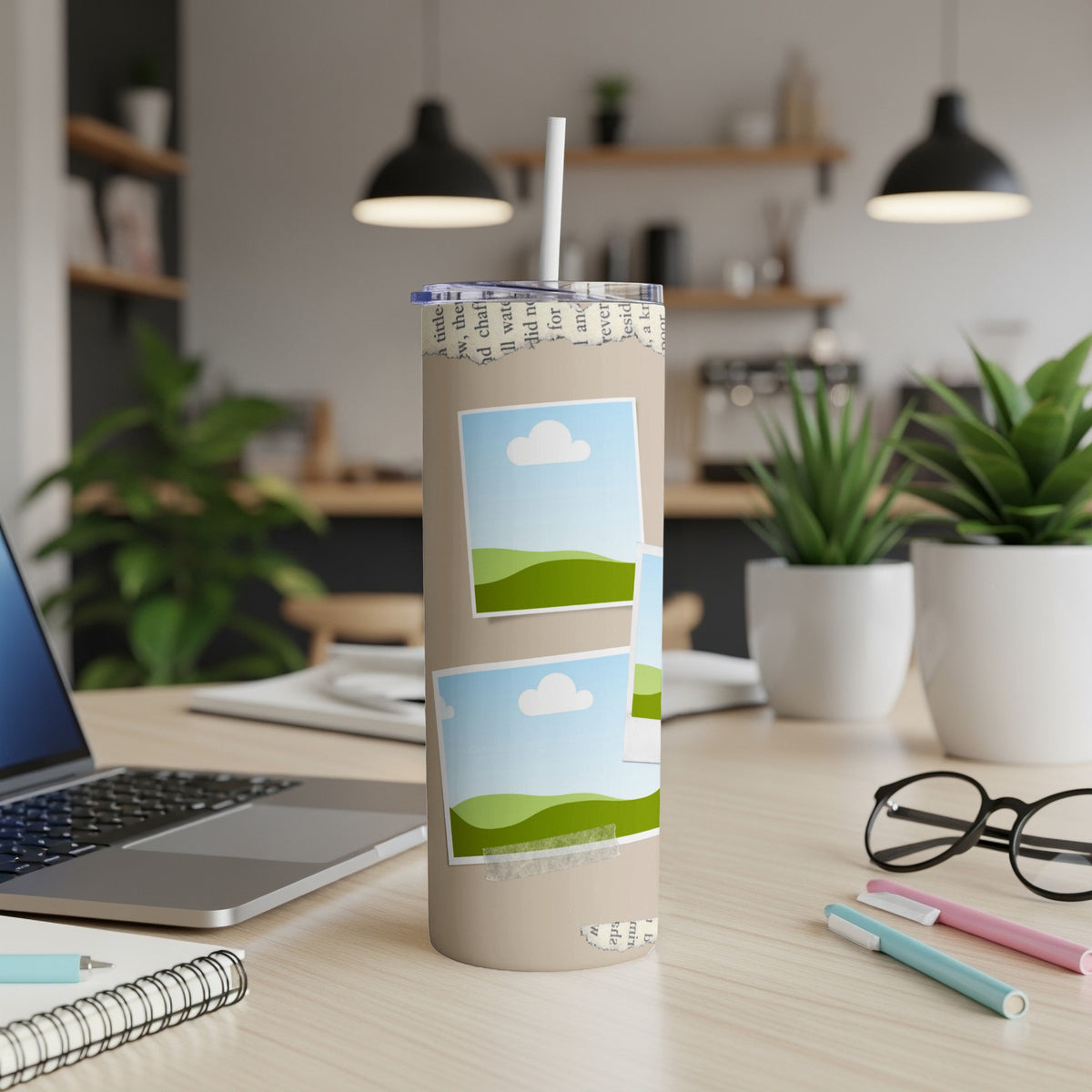 Tan tumbler with torn paper edge and photo stickers of landscapes.