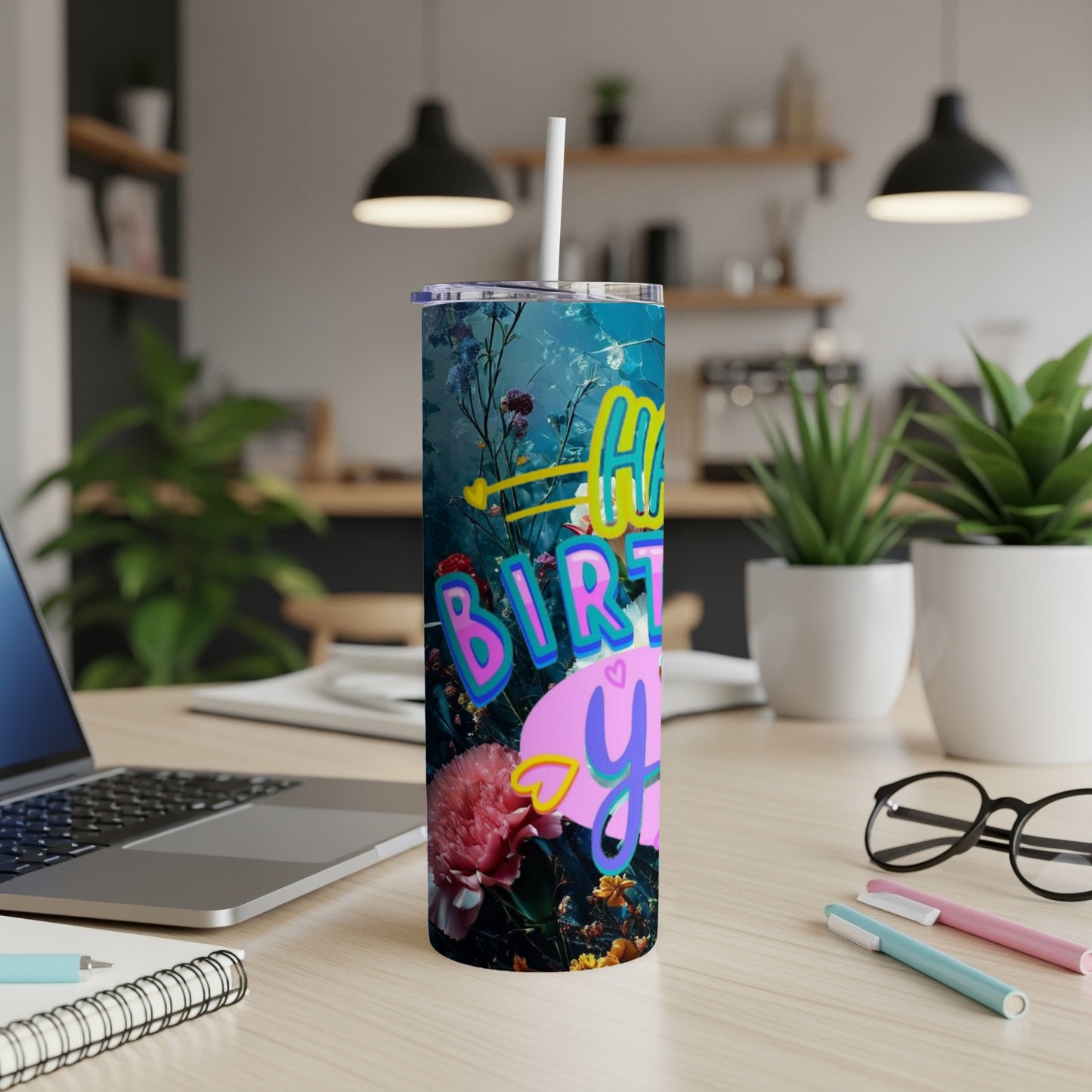 Happy Birthday you tumbler with floral design on a desk.