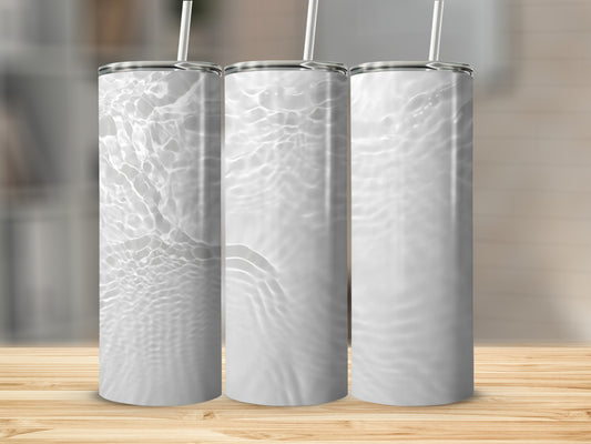Three white tumblers with water ripple pattern on wooden surface.