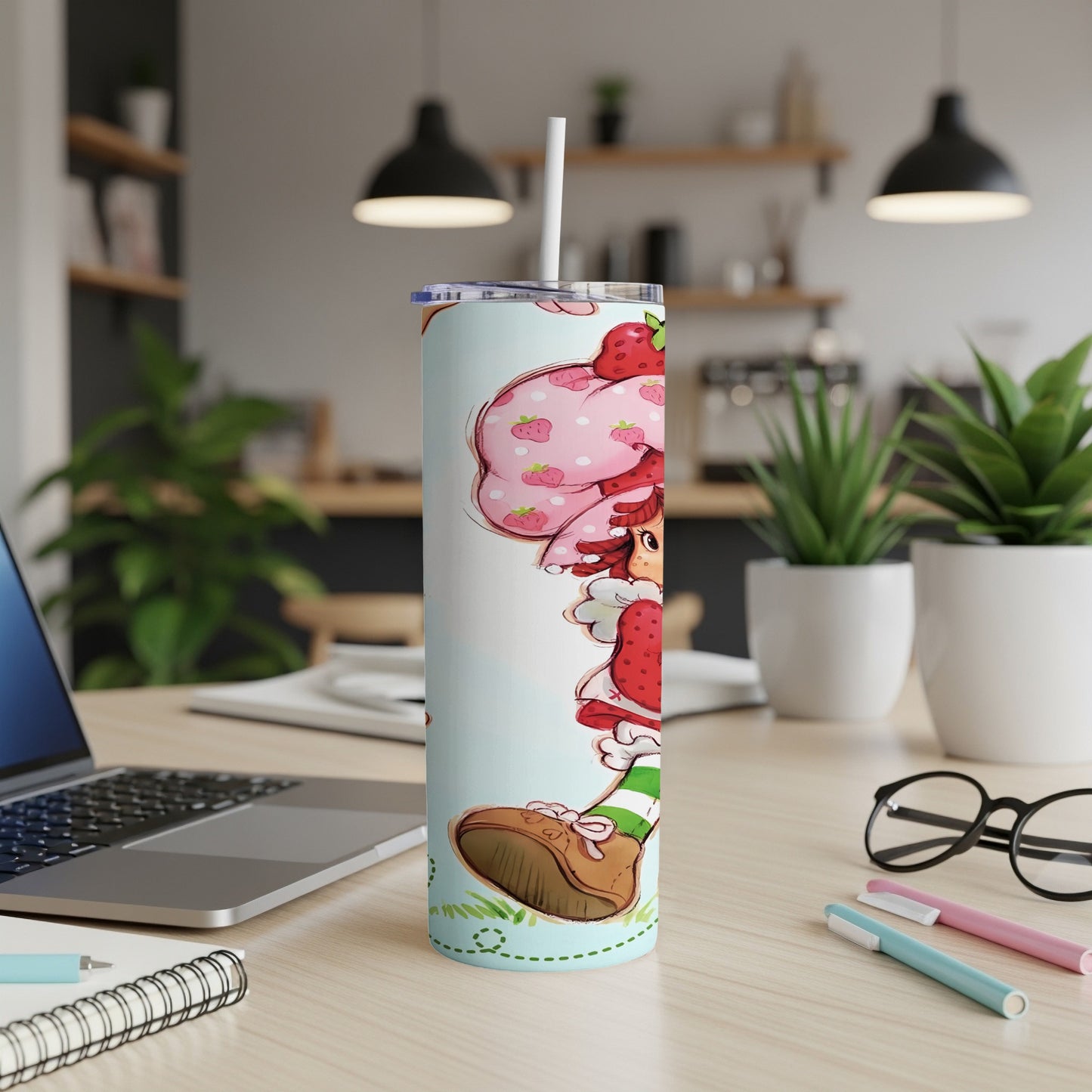 Strawberry Shortcake on a tumbler with a straw, office desk background.