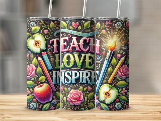 "Teach, Love, Inspire" tumbler with apples, roses, and art supplies on a wooden surface.