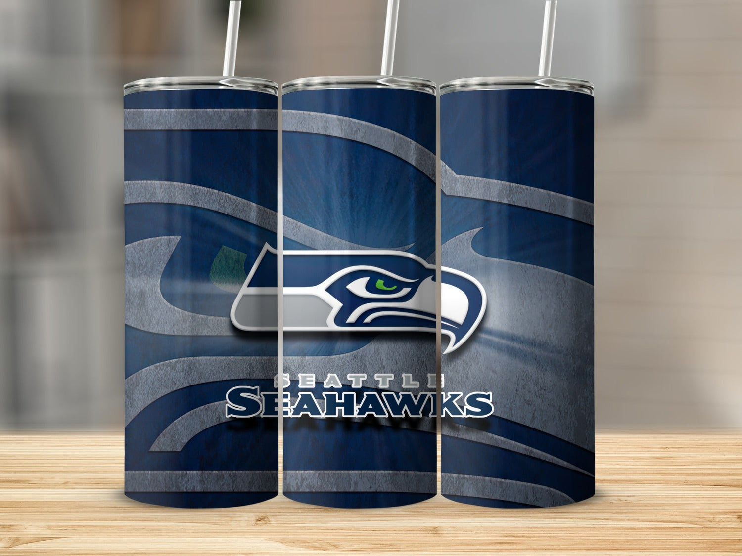 Seattle Seahawks logo and text on three navy blue tumblers with straws.