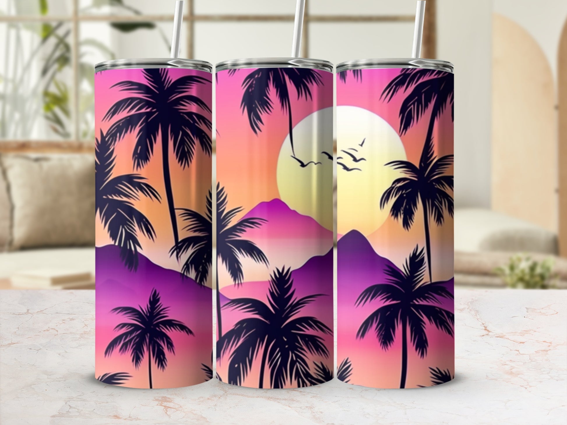 Three tumblers featuring a sunset with palm trees and mountains.