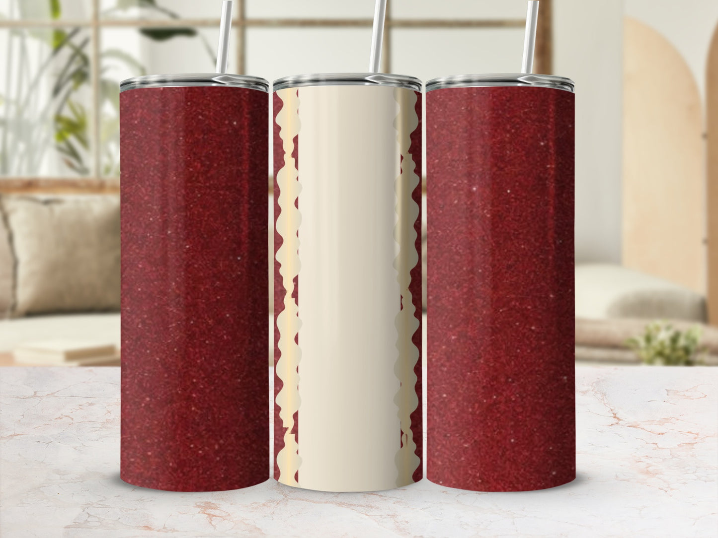 Three glitter tumblers, two red, one with creamy trim and straw.