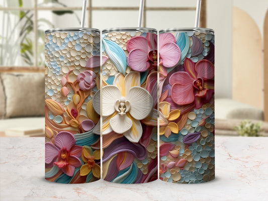 Floral relief on a textured tumbler with straw, on a marble surface.