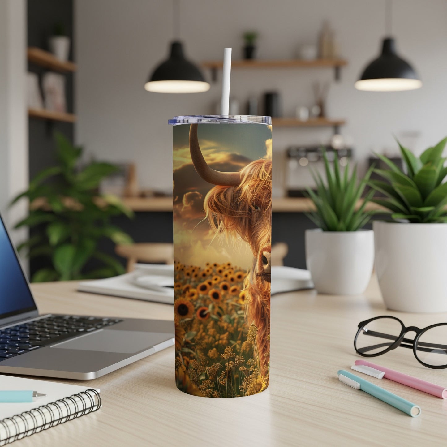 Highland cow portrait in a sunflower field at sunset on a tumbler.