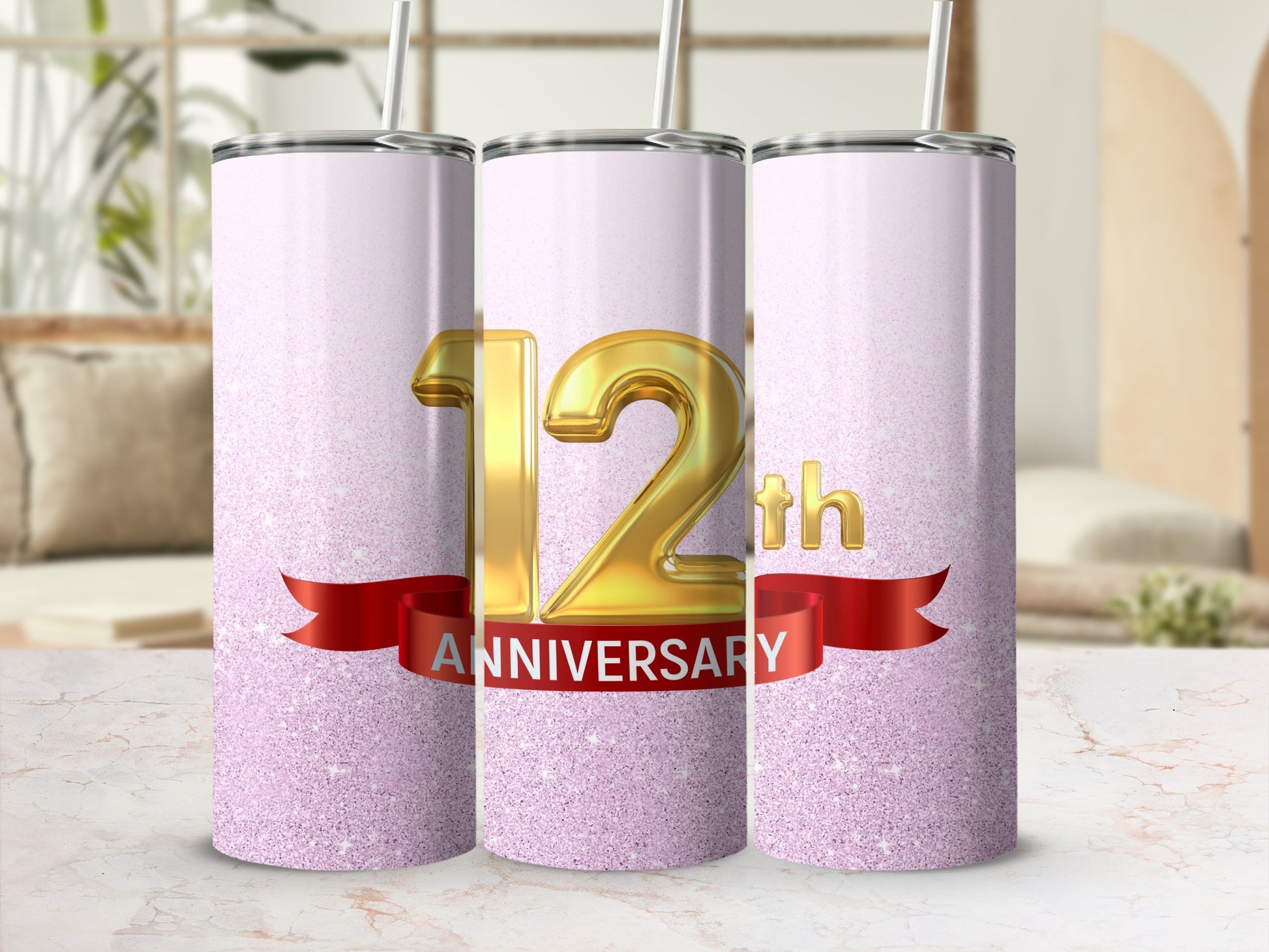 Three glitter tumblers celebrate a 12th anniversary with a red ribbon.