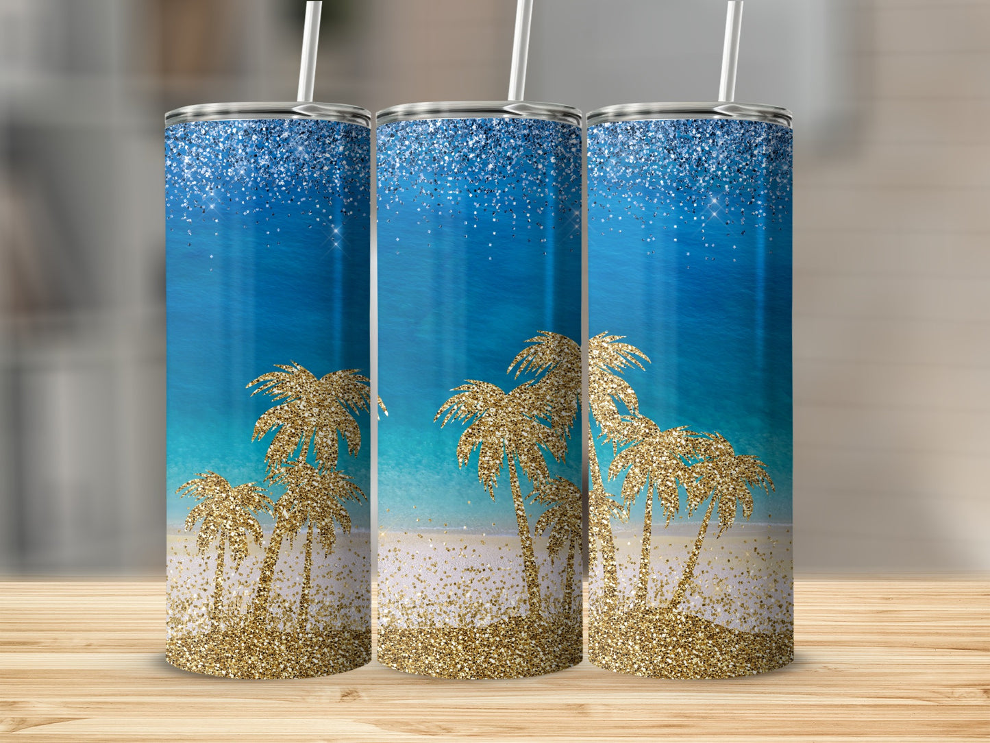 Three glittery tumblers with a beach scene and palm trees.
