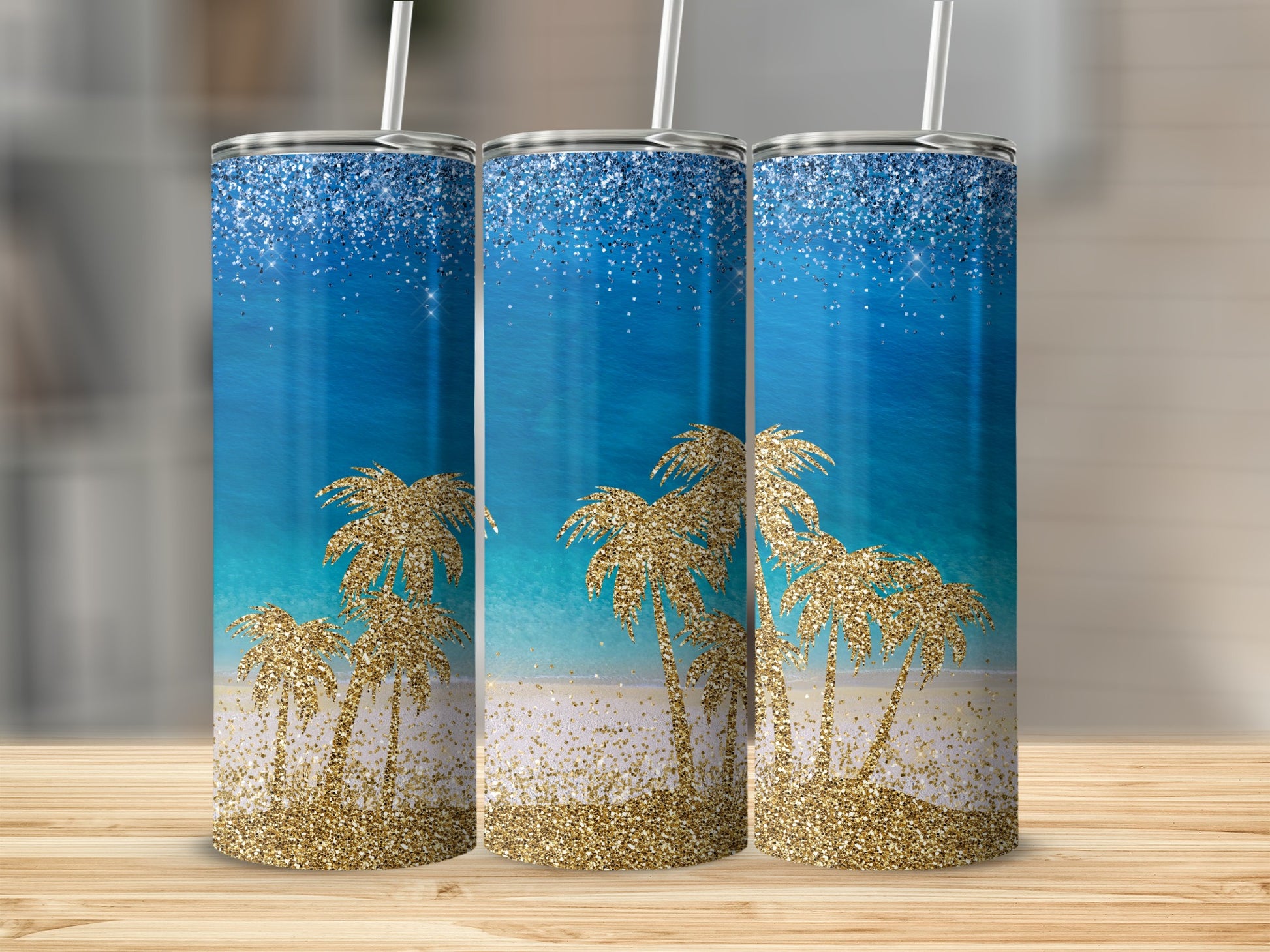 Three glittery tumblers with a beach scene and palm trees.