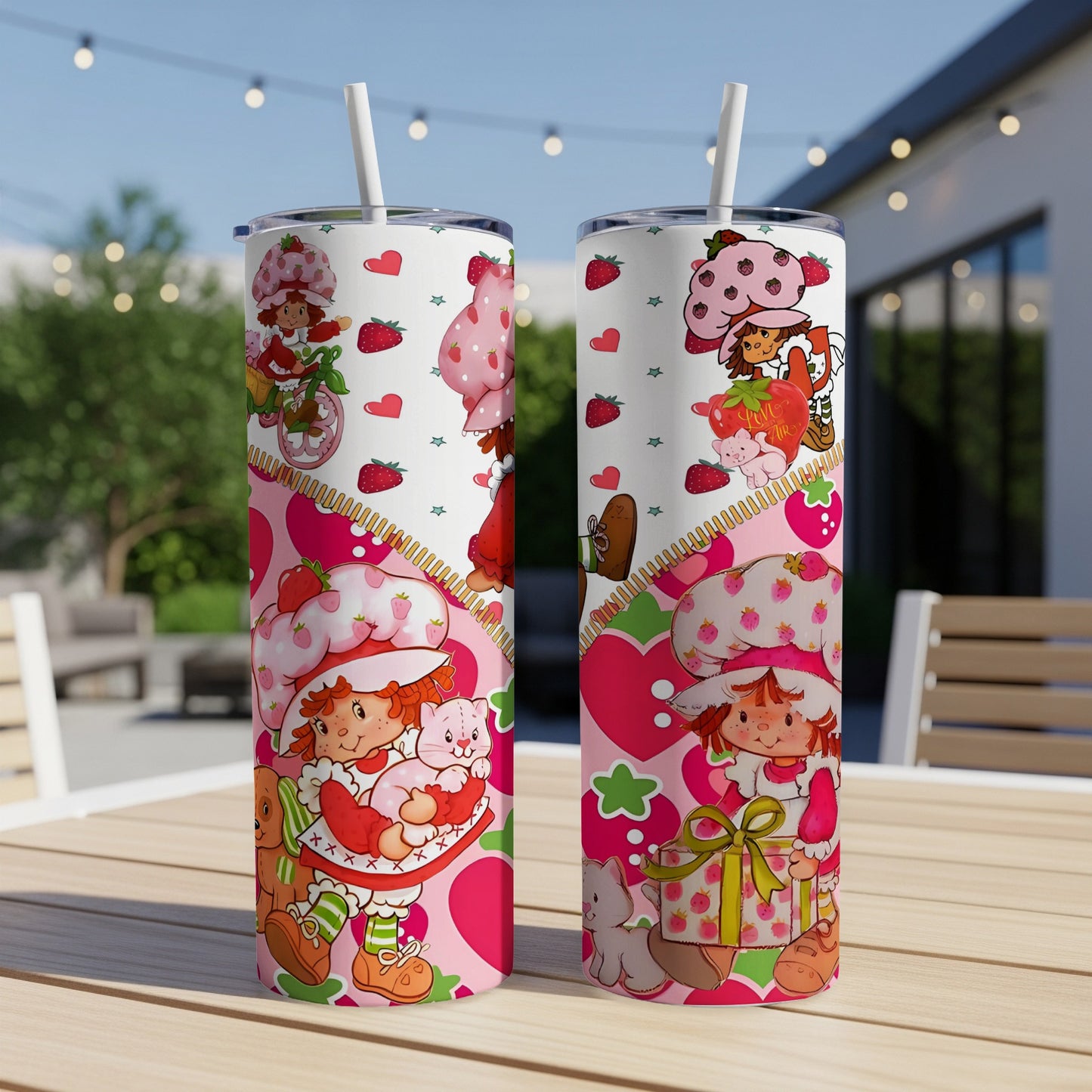 Two Strawberry Shortcake tumblers with character designs and heart accents.