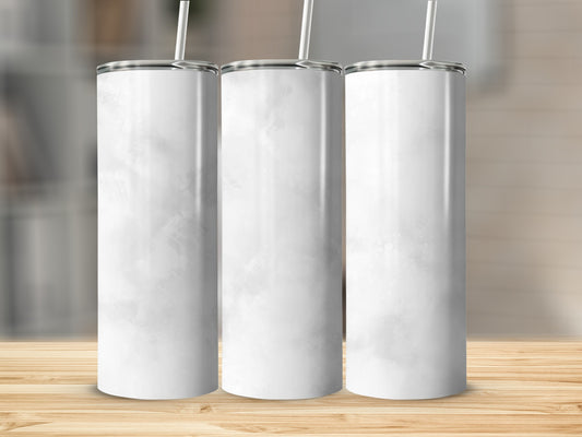 Three blank white tumblers with straws stand on a wooden surface.