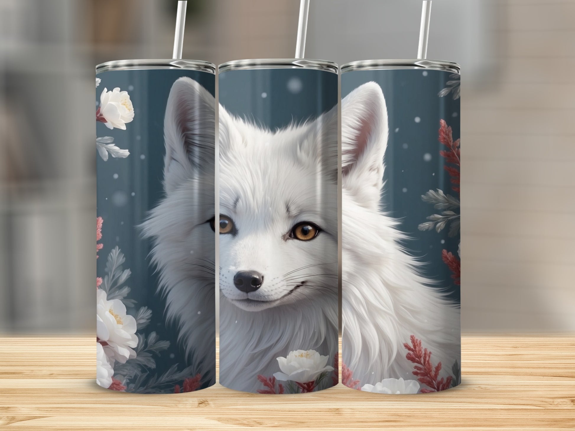 Arctic fox illustration on three tumblers with floral and snow accents.