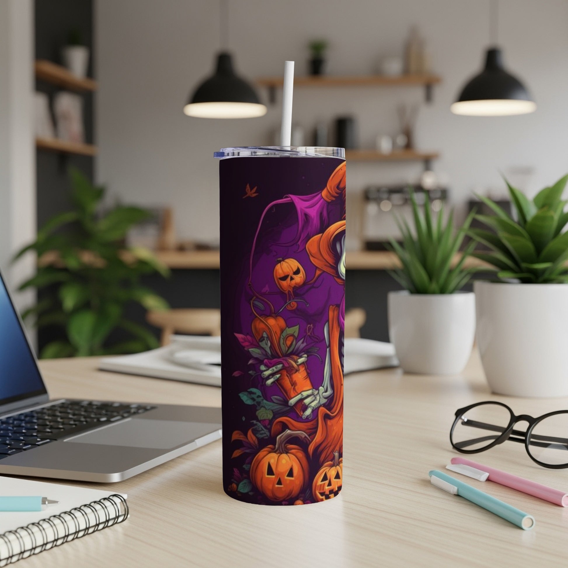 Halloween tumbler with jack-o'-lanterns and skeletal hand design.