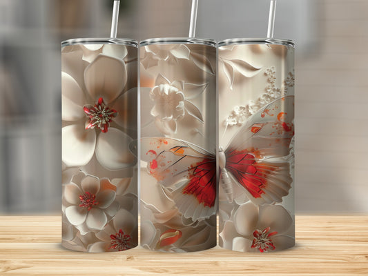 Three tumblers with floral and butterfly designs on a wooden surface.