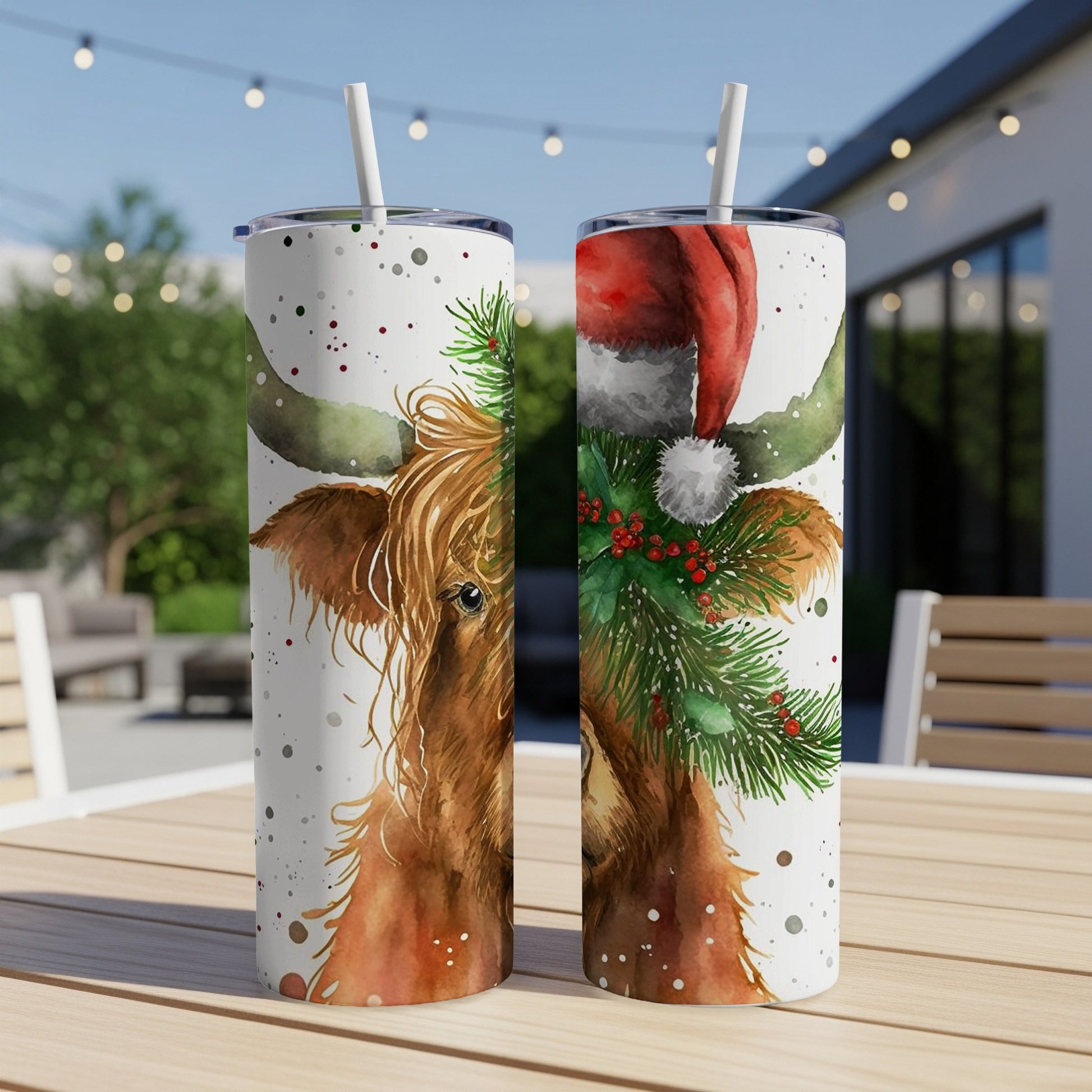 Highland cow with Christmas hat and greenery on a tumbler.