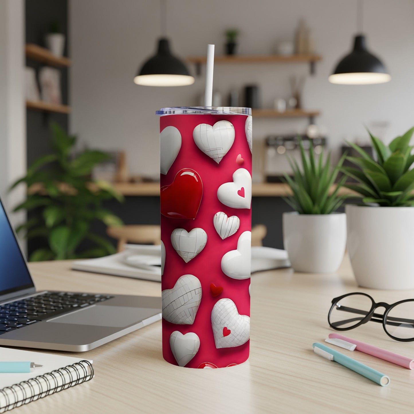 Red tumbler with white and red hearts and a white straw.