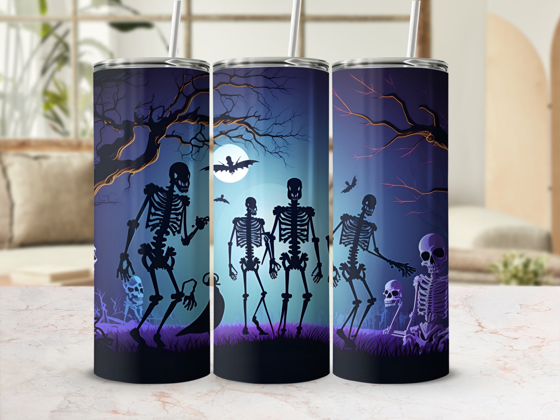 Tumbler with Halloween skeletons, bats, and a moonlit graveyard scene.