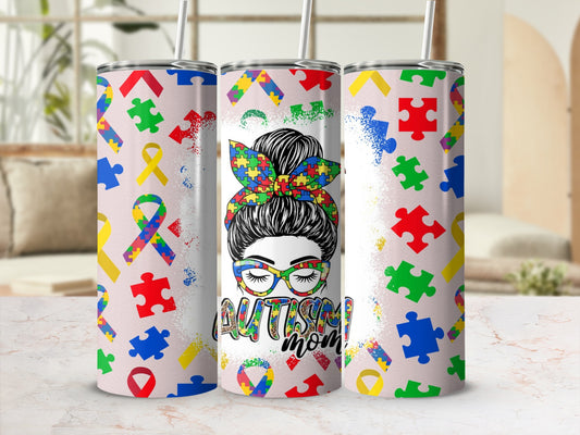 Tumbler with autism puzzle pieces and "Autism Mom" design.