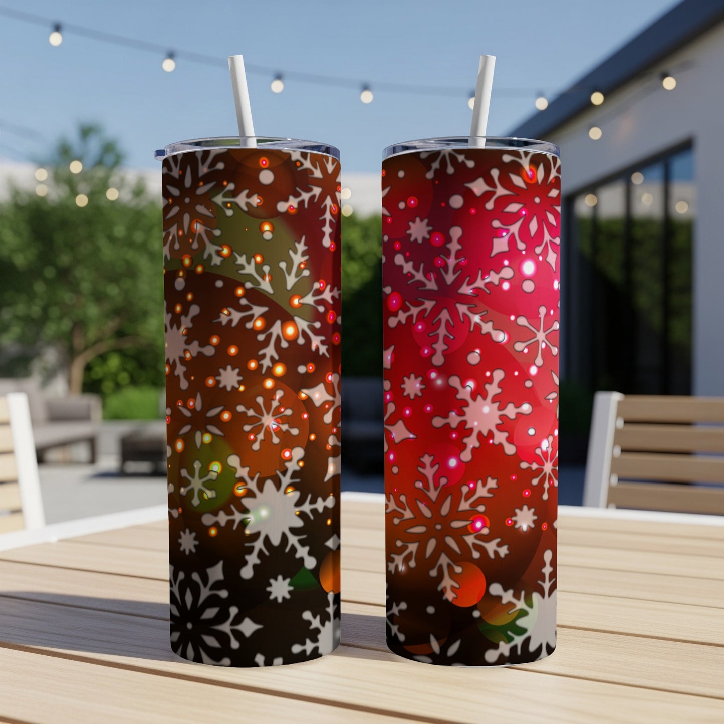 Two tumblers with snowflake and bokeh holiday designs.