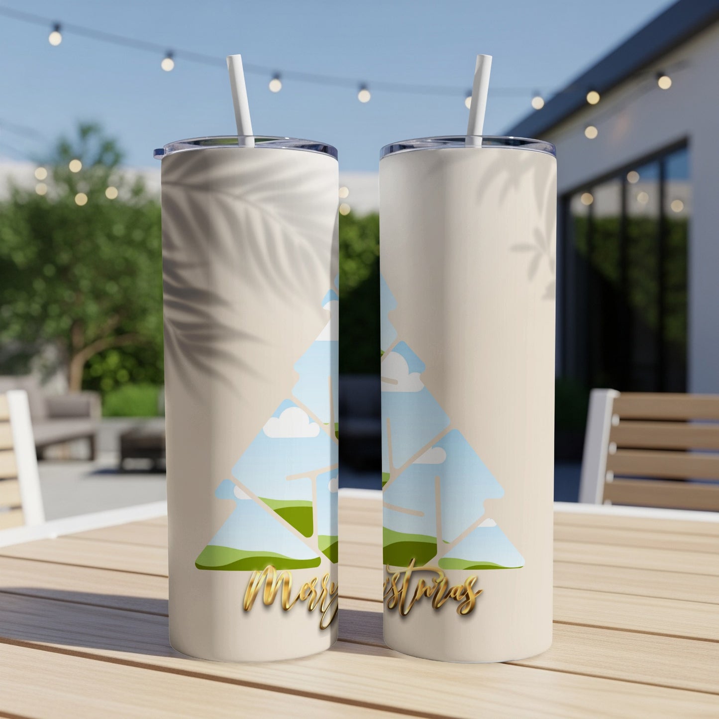 Two tan tumblers with a Christmas tree design and "Merry Christras" text.