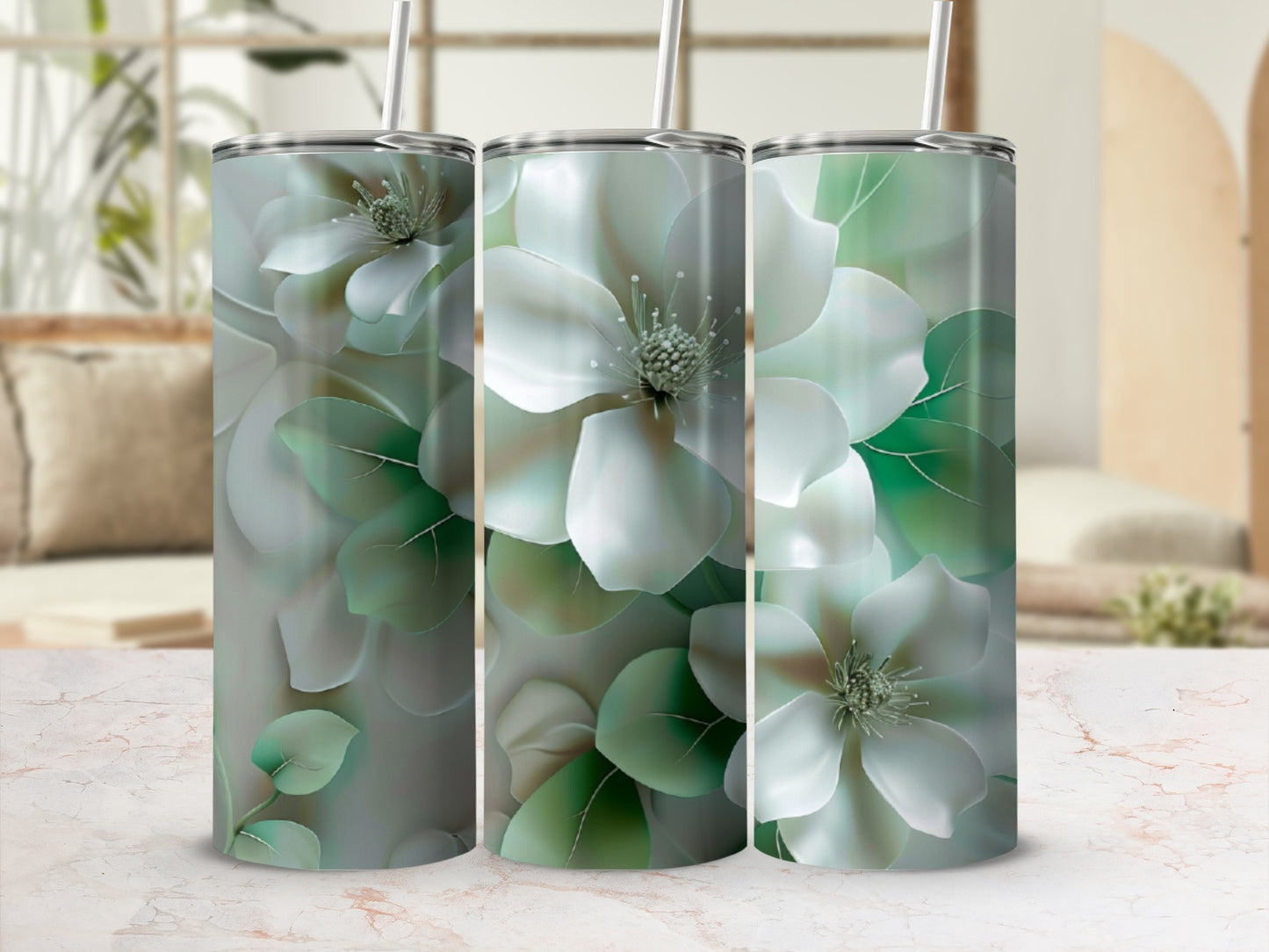 Three tumblers with large white magnolia flowers and green leaves.