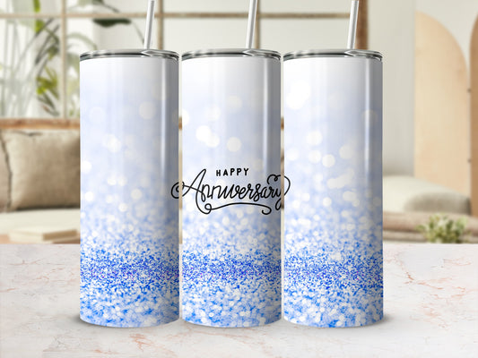 White tumbler with blue glitter and "Happy Anniversary" text.